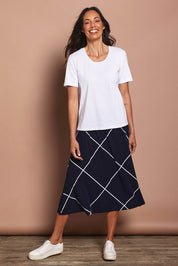 Model Amanda wearing size 10 of The Pull On Skirt in colour Navywhite (Blue), from the front, showing the whole outfit