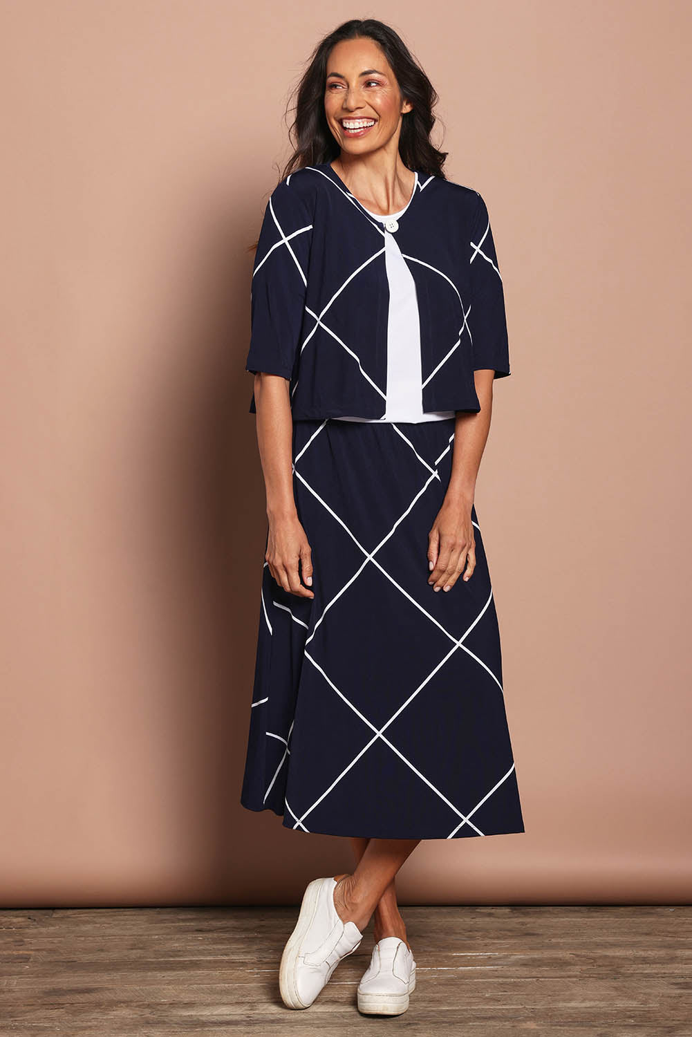 Model Amanda wearing size 10 of The Pull On Skirt in colour Navywhite (Blue), from the front, showing the whole outfit
