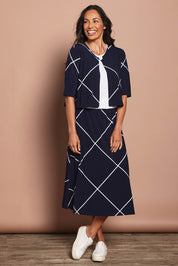 Model Amanda wearing size 10 of The Pull On Skirt in colour Navywhite (Blue), from the front, showing the whole outfit
