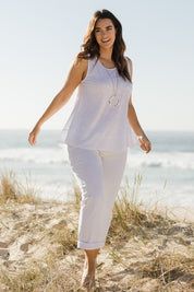 Model Laura wearing size 14 of The Swing Tank in colour White (White), from the front, showing the whole outfit