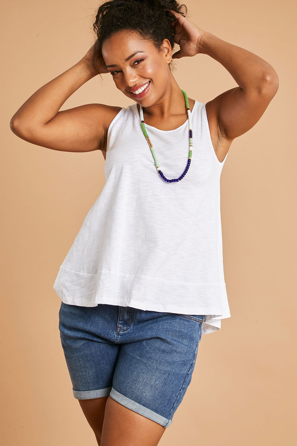 Model Noli wearing size 14 of The Swing Tank in colour White (White), from the front, showing the whole outfit