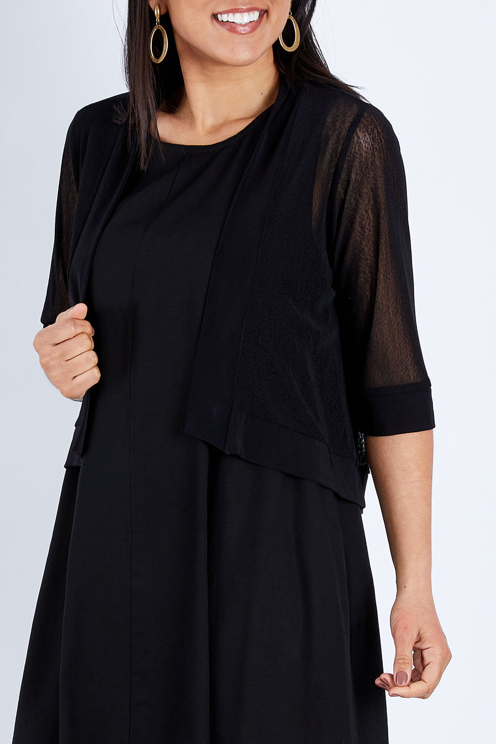 Model Pamela wearing size 10 of The Summer Shrug in colour Black (Black), from the front, cropped image