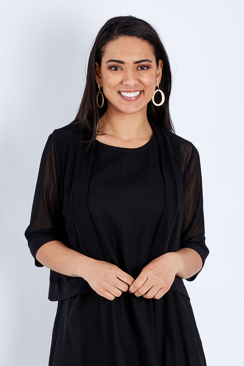 Model Pamela wearing size 10 of The Summer Shrug in colour Black (Black), from the front, cropped image