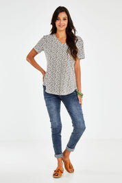 Model Vitoria wearing size 10 of The Feeling Spotty Tee in colour Khaki (Green), from the front, showing the whole outfit