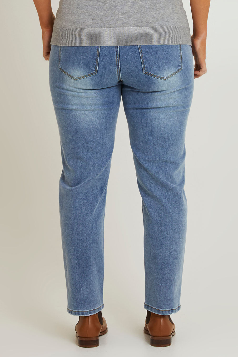 Model Laura wearing size 14 of The Boyfriend Slim Leg Jean in colour Blue (Blue), from the back