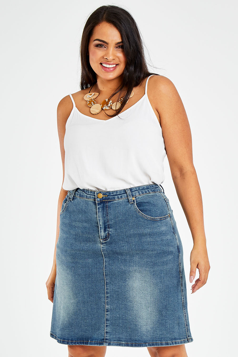 Model Sasha-Lee wearing size 16 of The 5 Pocket Denim Skirt in colour Denim (Blue), from the front, cropped image