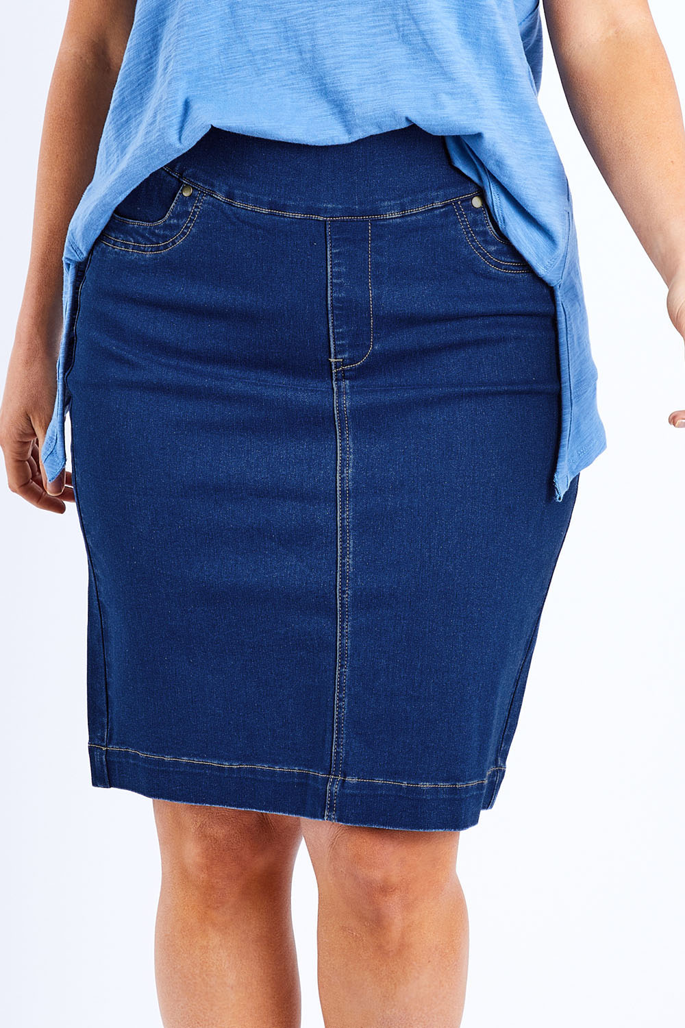 Model Laura wearing size 14 of The Pull On Denim Skirt in colour Denim (Blue), from the front, cropped image