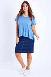 Model Laura wearing size 14 of The Pull On Denim Skirt in colour Denim (Blue), from the front, showing the whole outfit
