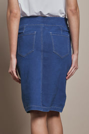 Model Madeline wearing size 10 of The Pull On Denim Skirt in colour Denim (Blue), from the back