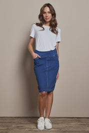 Model Madeline wearing size 10 of The Pull On Denim Skirt in colour Denim (Blue), from the front, showing the whole outfit