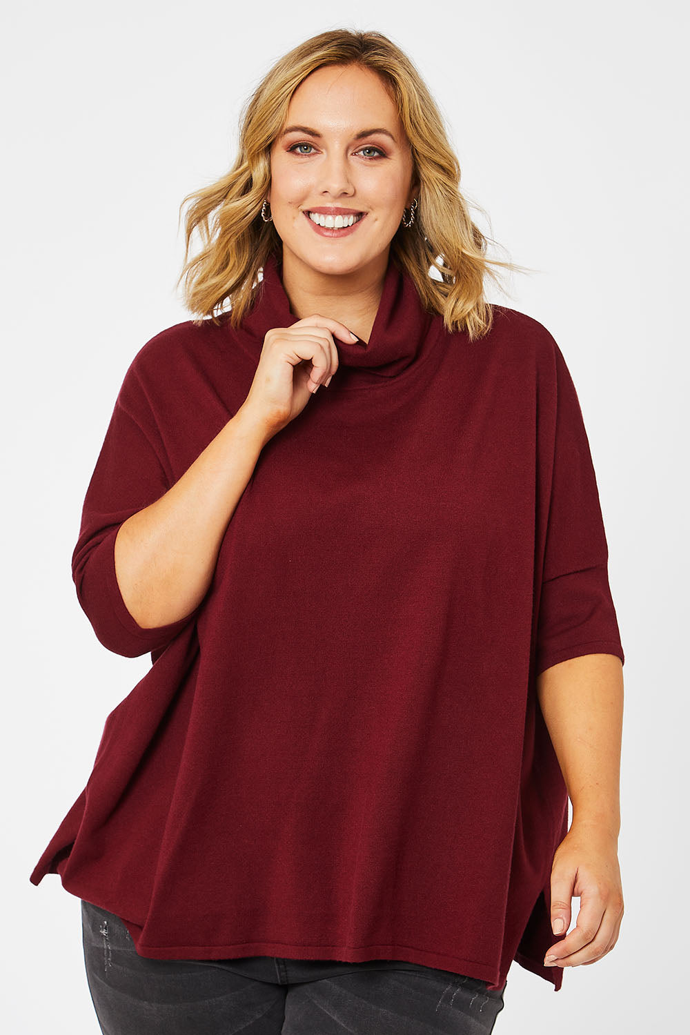 Model Jess wearing size L of The Roll Neck Easy Wear Jumper in colour Shiraz (Red), from the front, cropped image