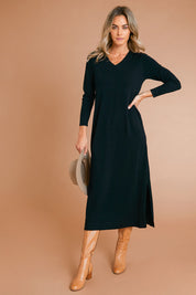 Model Alice wearing size S of The Comfort True Knit Dress in colour Black (Black), from the front, showing the whole outfit