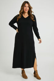 Model Laura wearing size L of The Comfort True Knit Dress in colour Black (Black), from the front, showing the whole outfit