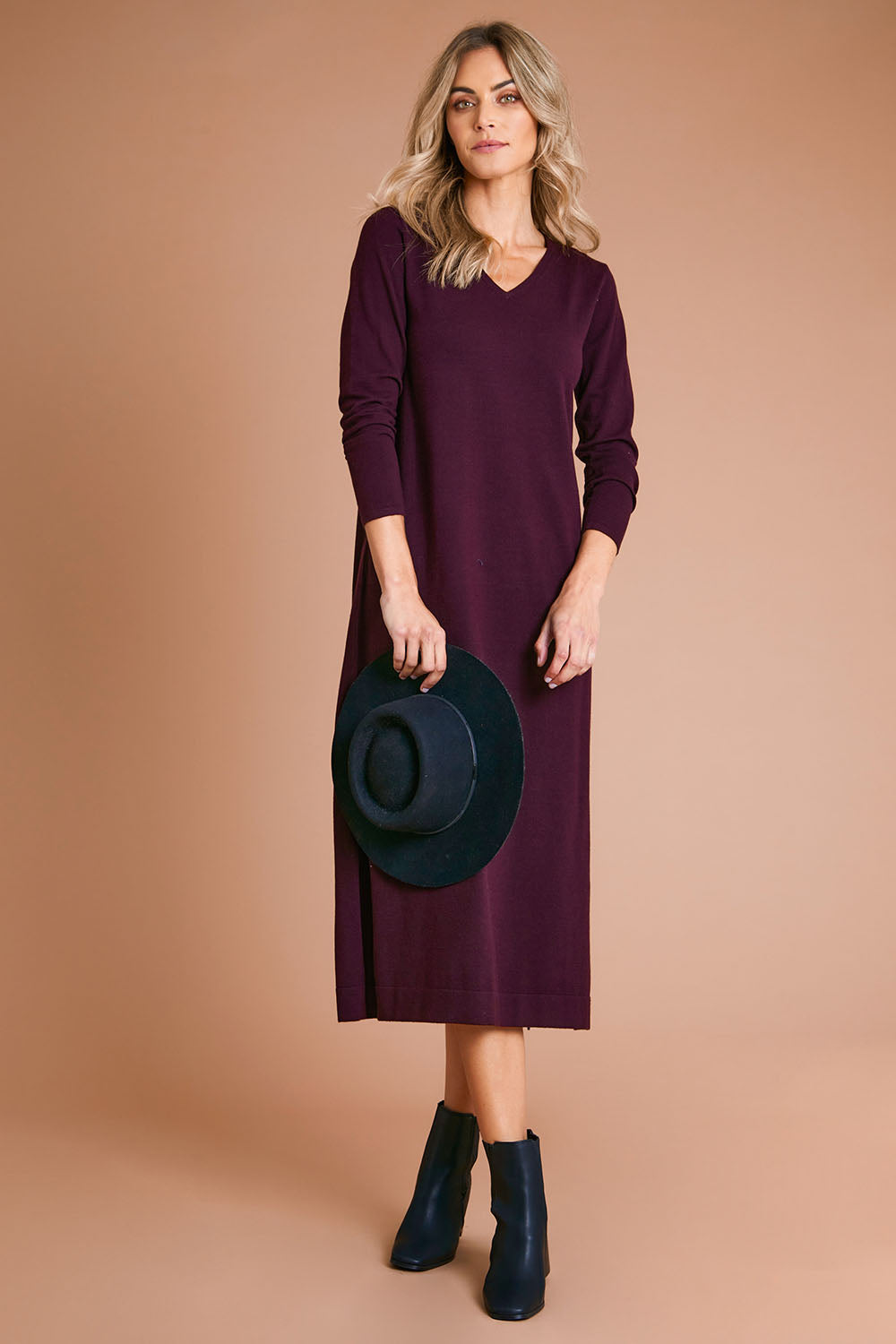 Model Alice wearing size S of The Comfort True Knit Dress in colour Burntplum (Purple), from the front, showing the whole outfit