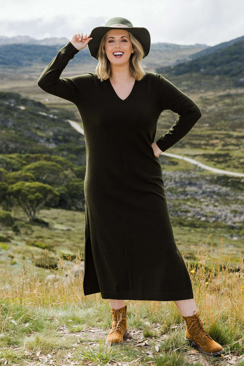 Model Jess wearing size L of The Comfort True Knit Dress in colour Darkolive (Green), from the front, showing the whole outfit
