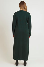 Model Chanel wearing size XL of The Comfort True Knit Dress in colour Darkpine (Green), from the back