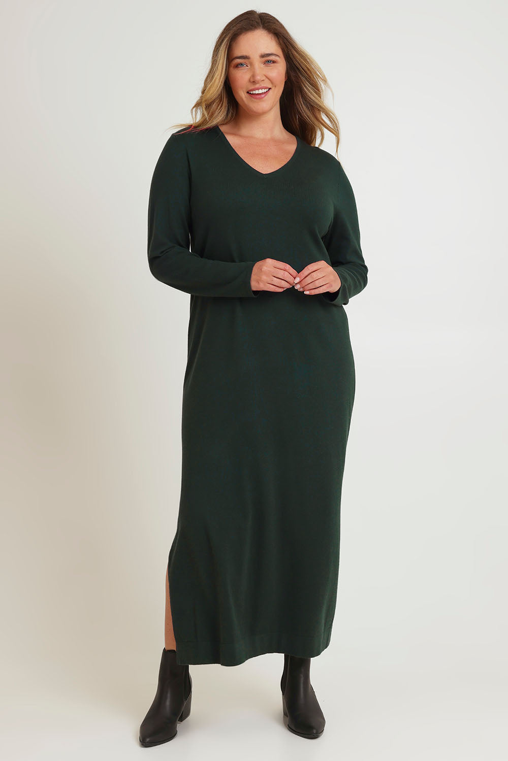 Model Chanel wearing size XL of The Comfort True Knit Dress in colour Darkpine (Green), from the front, showing the whole outfit