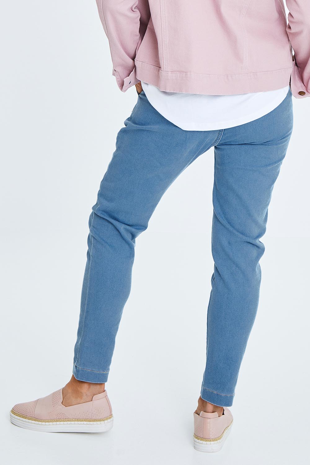 Model Cara wearing size 10 of The Weekend Pull On Jogger Jean in colour Denim (Blue), from the back