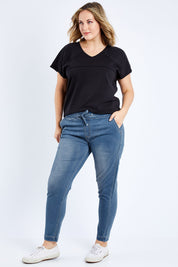 Model Jess wearing size 14 of The Weekend Pull On Jogger Jean in colour Denim (Blue), from the front, showing the whole outfit