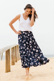 Model Amanda wearing size 10 of The Pull On Swing Print Skirt in colour Daisyprint (Blue), from the front, showing the whole outfit
