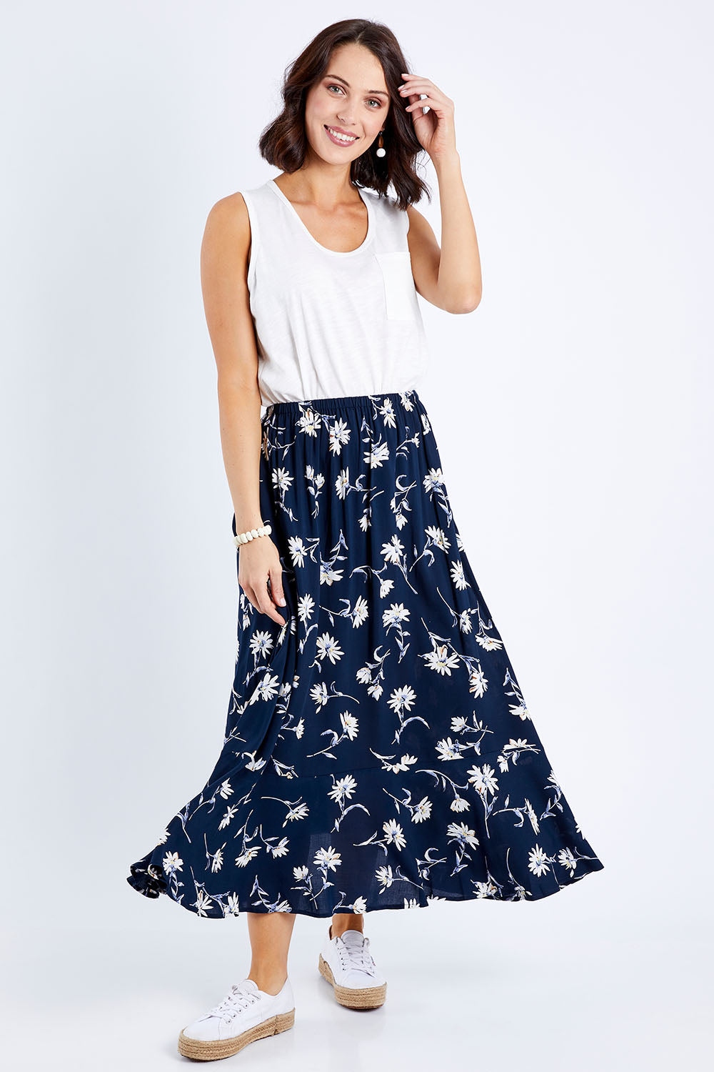 Model Andrea wearing size 10 of The Pull On Swing Print Skirt in colour Daisyprint (Blue), from the front, showing the whole outfit