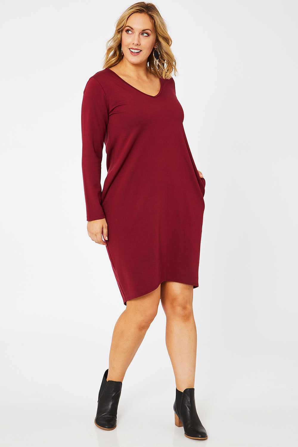 Model Jess wearing size 14 of The V Neck Essential Ponte Dress in colour Pomegranat (Red), from the front, showing the whole outfit