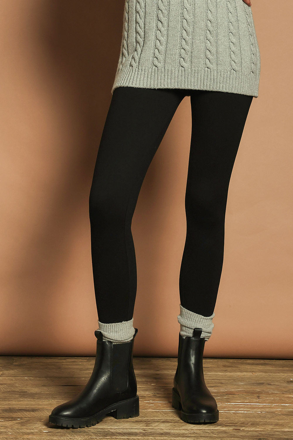 Model Madeline wearing size 10 of The Essential Ponte Legging in colour Black (Black), from the front, cropped image