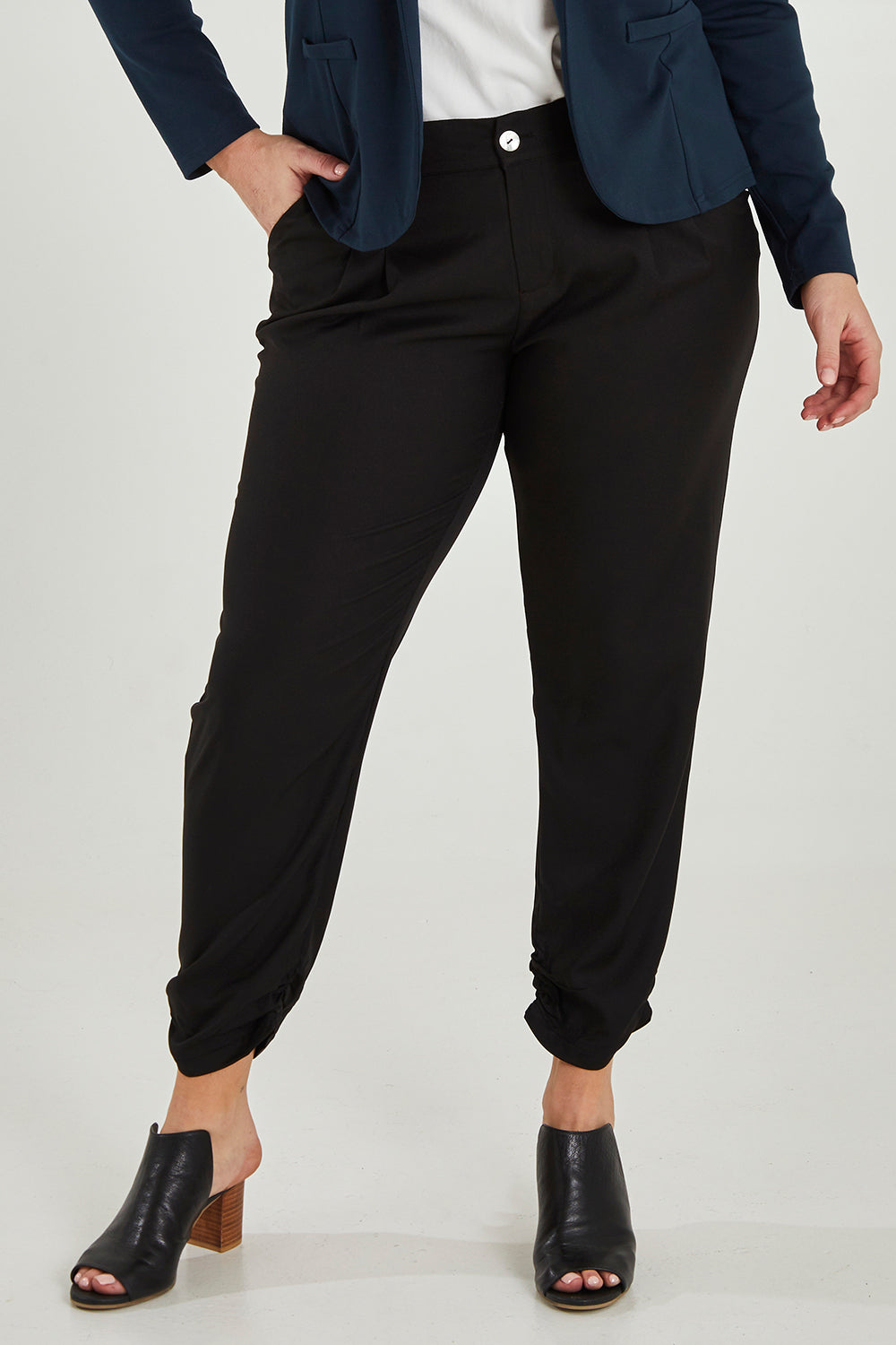 Model Maddy wearing size 16 of The Full Length Best Seller Pant in colour Black (Black), from the front, cropped image