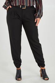 Model Monique wearing size 14 of The Full Length Best Seller Pant in colour Black (Black), from the front, cropped image