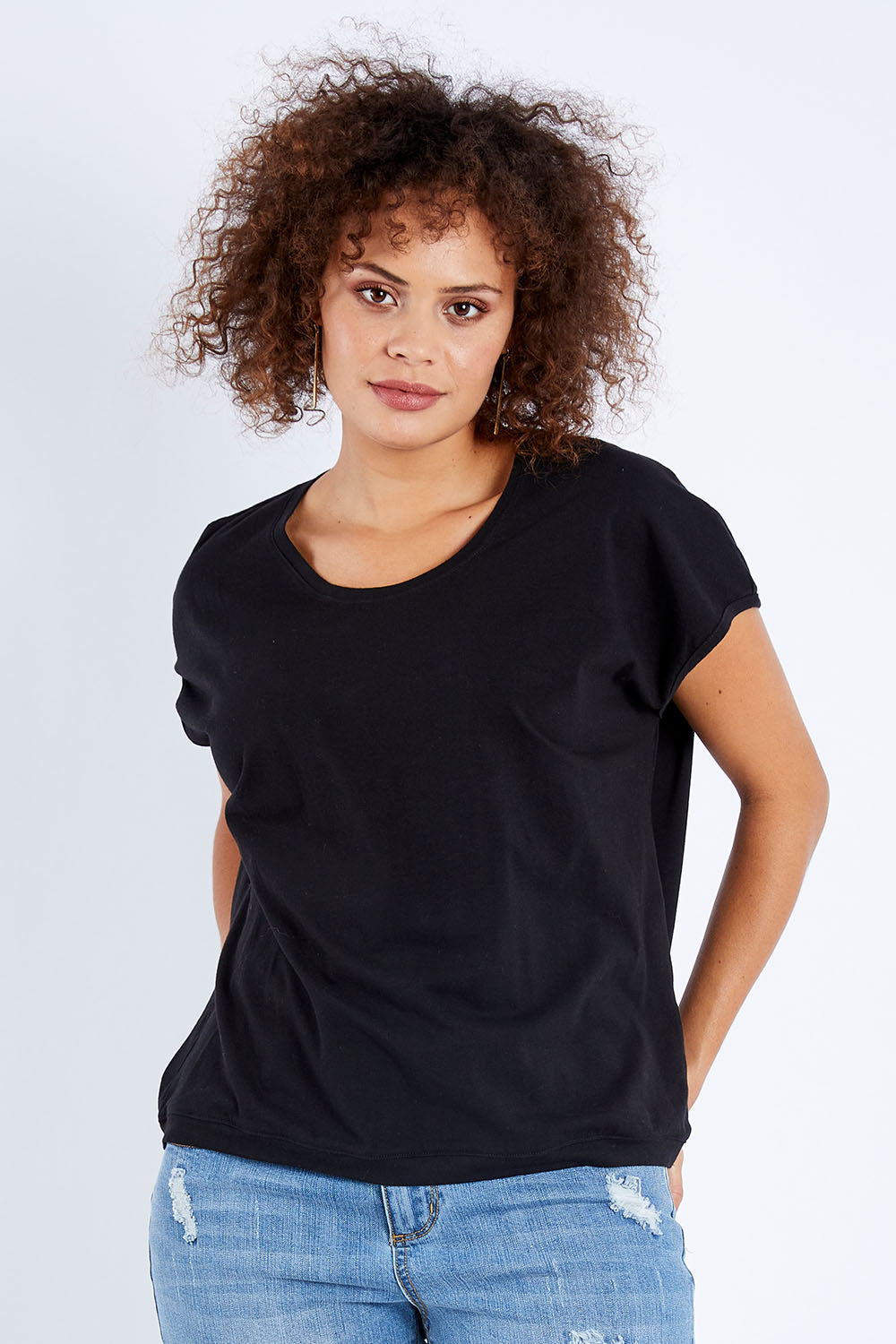 Model Lala wearing size 10 of The Shell Tee in colour Black (Black), from the front, cropped image