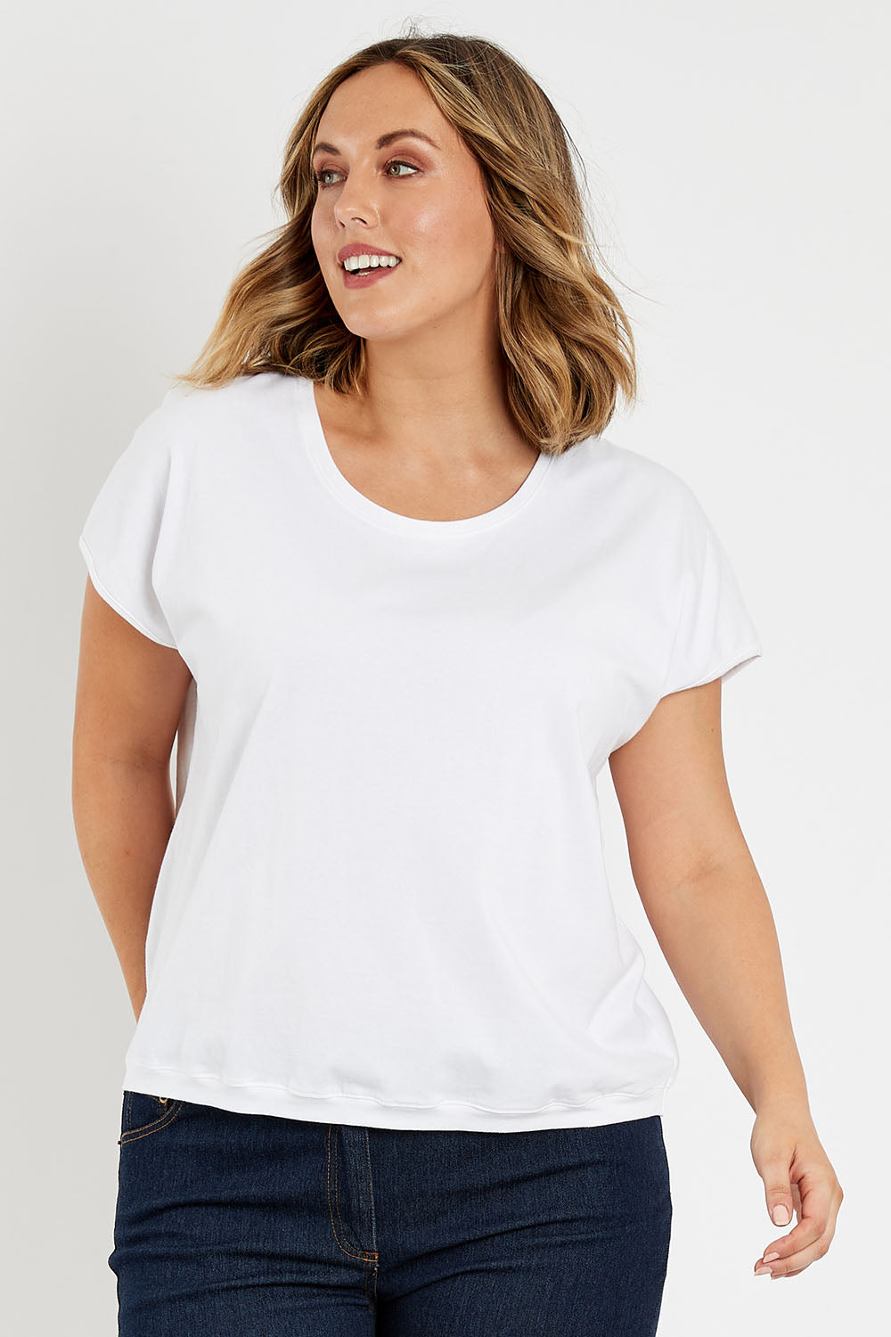 Model Jess wearing size 14 of The Shell Tee in colour White (White), from the front, cropped image