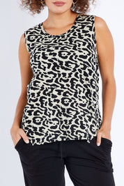 Model Lala wearing size 10 of The Step Hem Tank in colour Animal (Green), from the front, cropped image