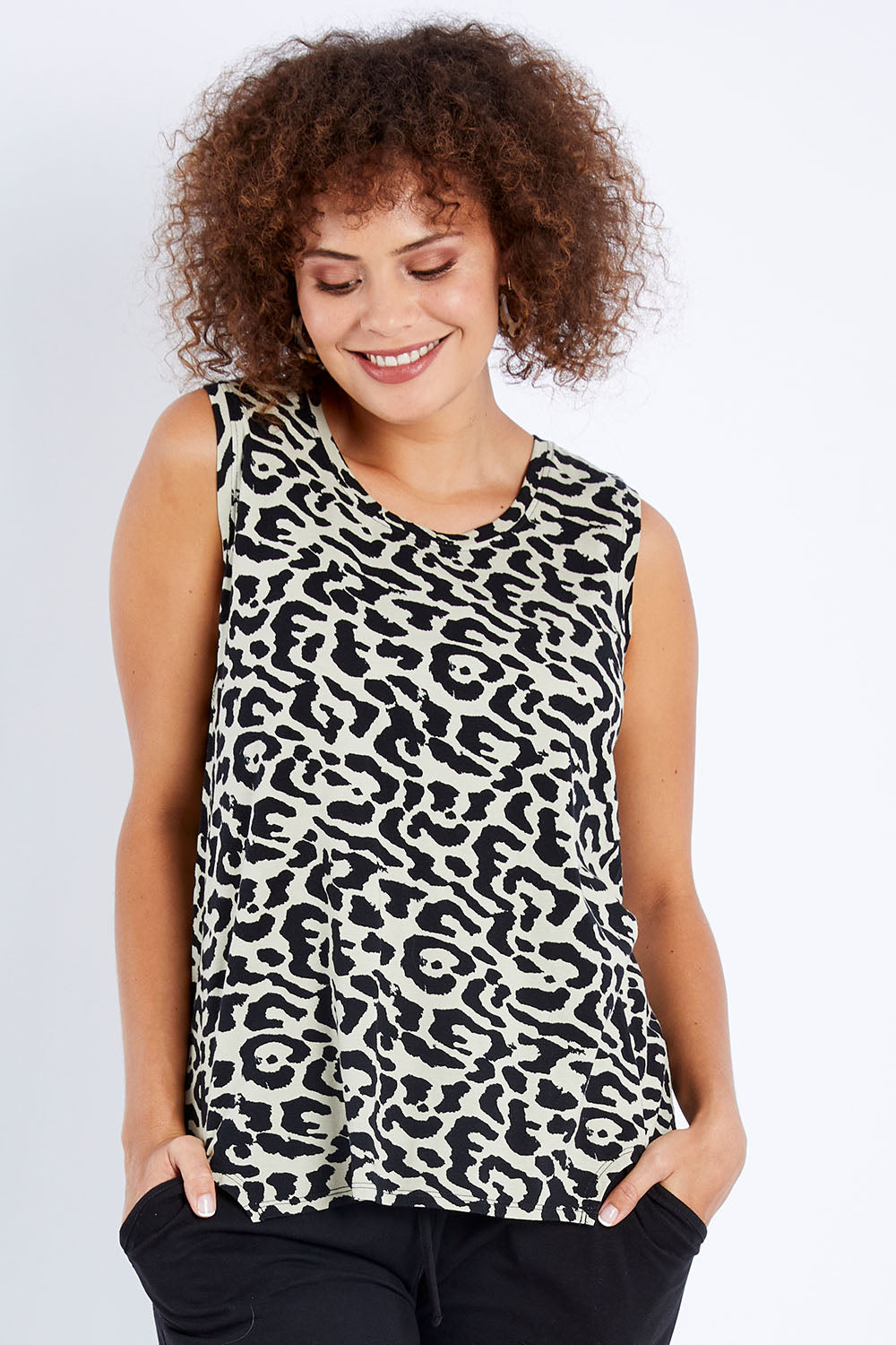 Model Lala wearing size 10 of The Step Hem Tank in colour Animal (Green), from the front, cropped image