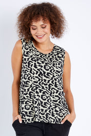 Model Lala wearing size 10 of The Step Hem Tank in colour Animal (Green), from the front, cropped image