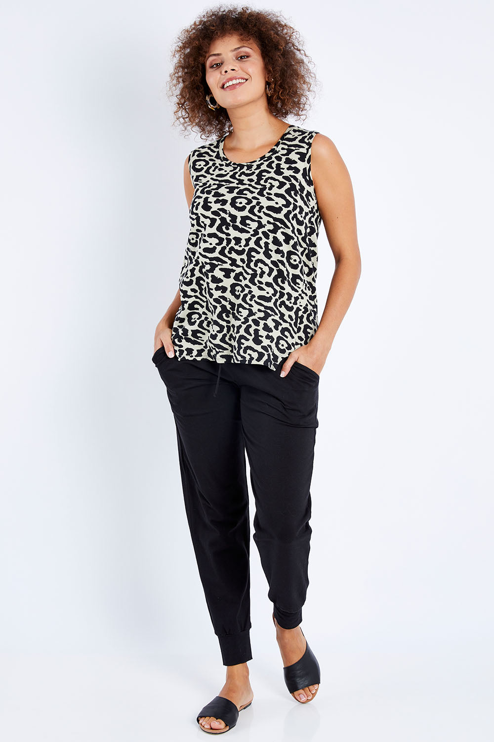 Model Lala wearing size 10 of The Step Hem Tank in colour Animal (Green), from the front, showing the whole outfit