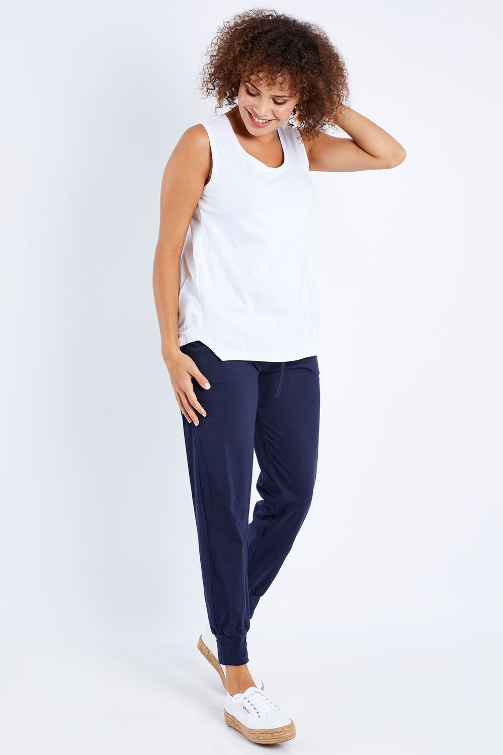 Model Lala wearing size 10 of The Step Hem Tank in colour White (White), from the front, showing the whole outfit
