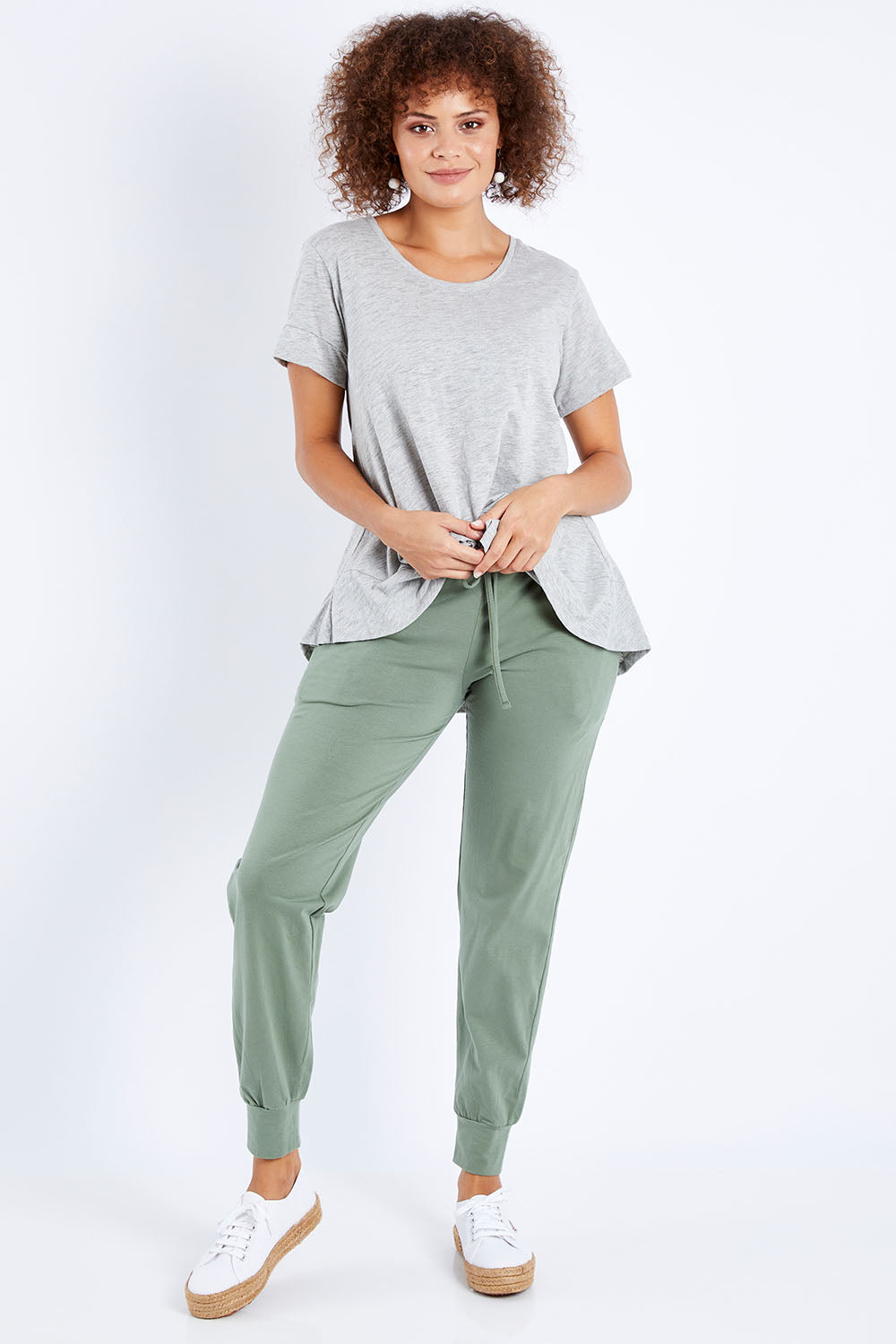 Model Lala wearing size 10 of The Everyday Pant in colour Khaki (Green), from the front, showing the whole outfit