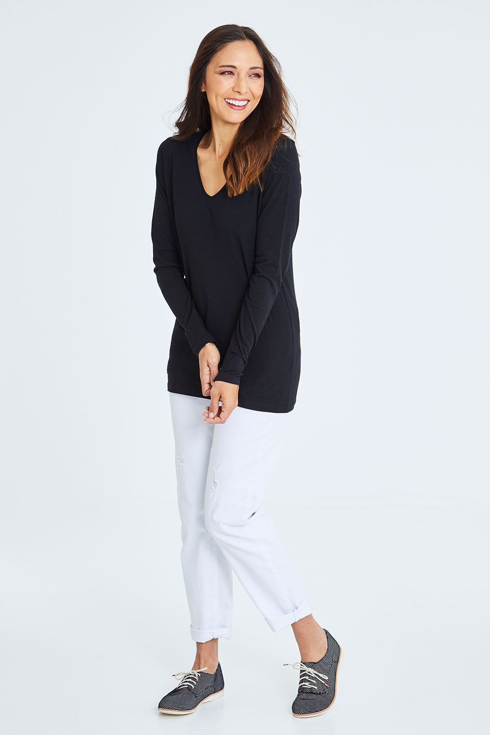 Model Cara wearing size 10 of The Long Sleeve V Neck Tee in colour Black (Black), from the front, showing the whole outfit