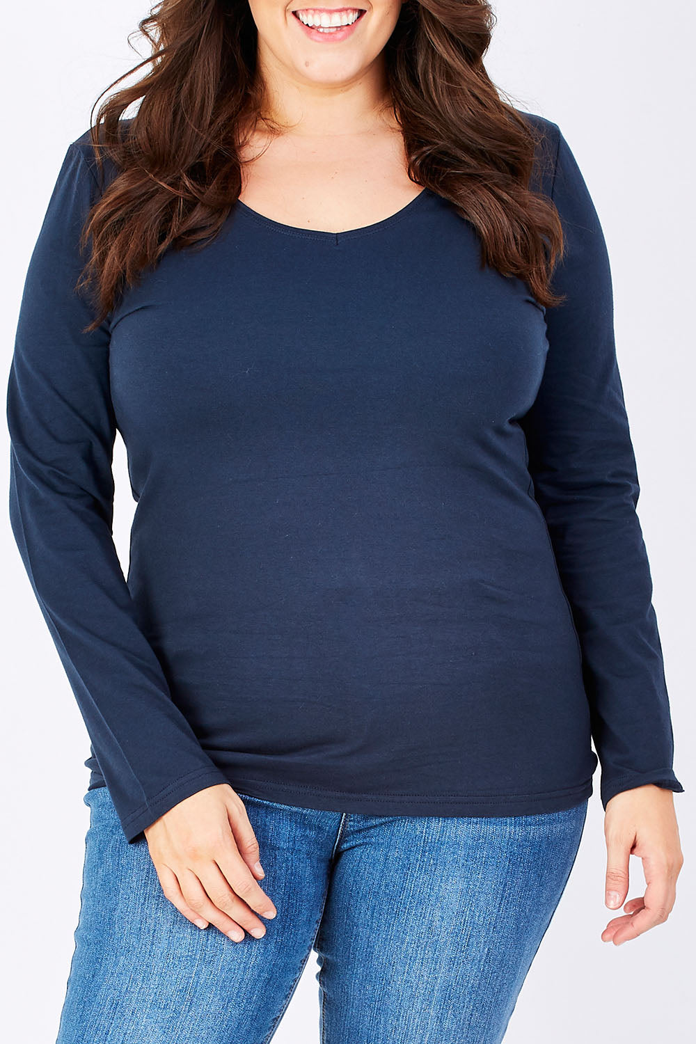 Model Mae wearing size 16 of The Long Sleeve V Neck Tee in colour Navy (Blue), from the front, cropped image