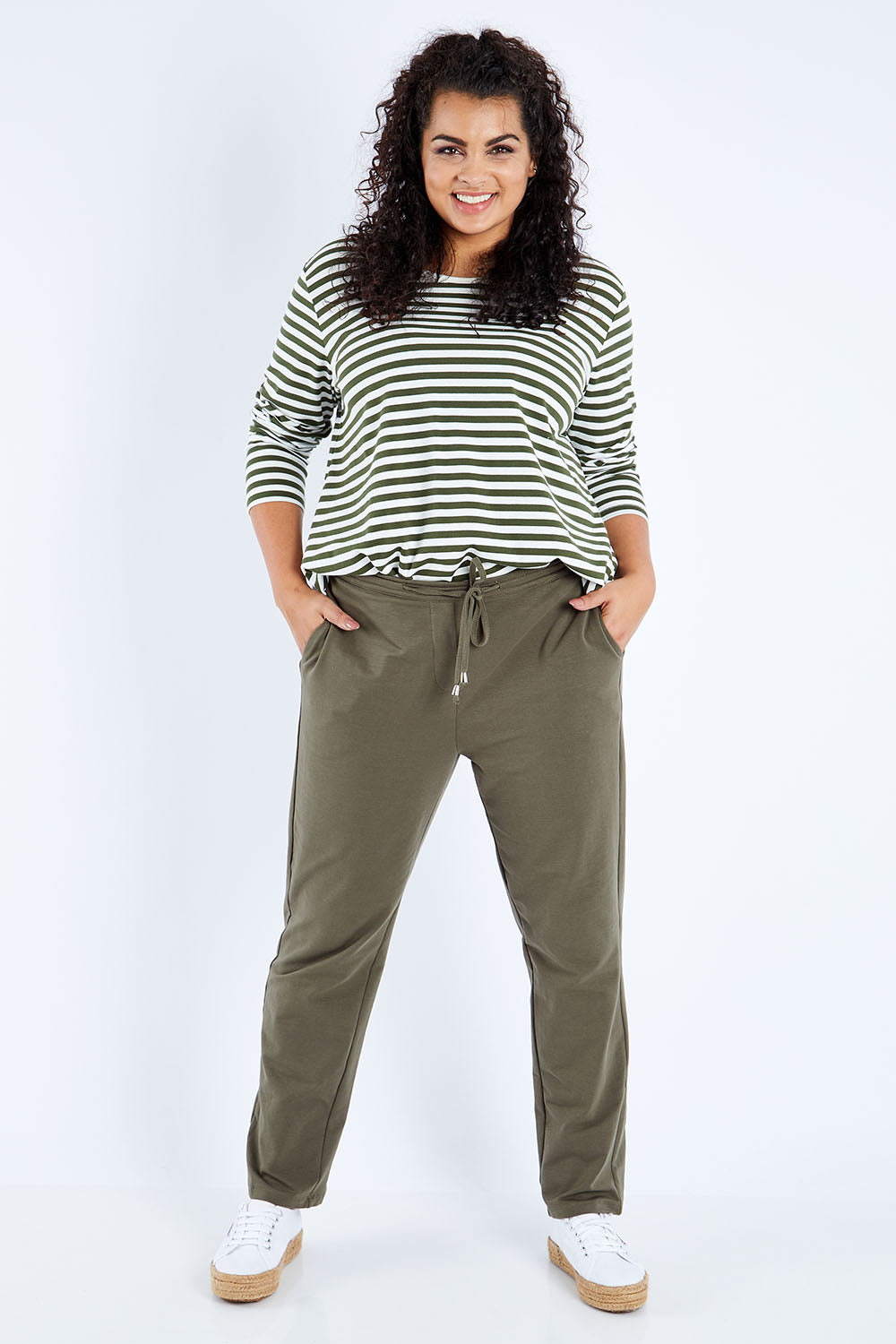 Model Sasha-Lee wearing size 16 of The Easy Wear Pull On Pant in colour Khaki (Green), from the front, showing the whole outfit