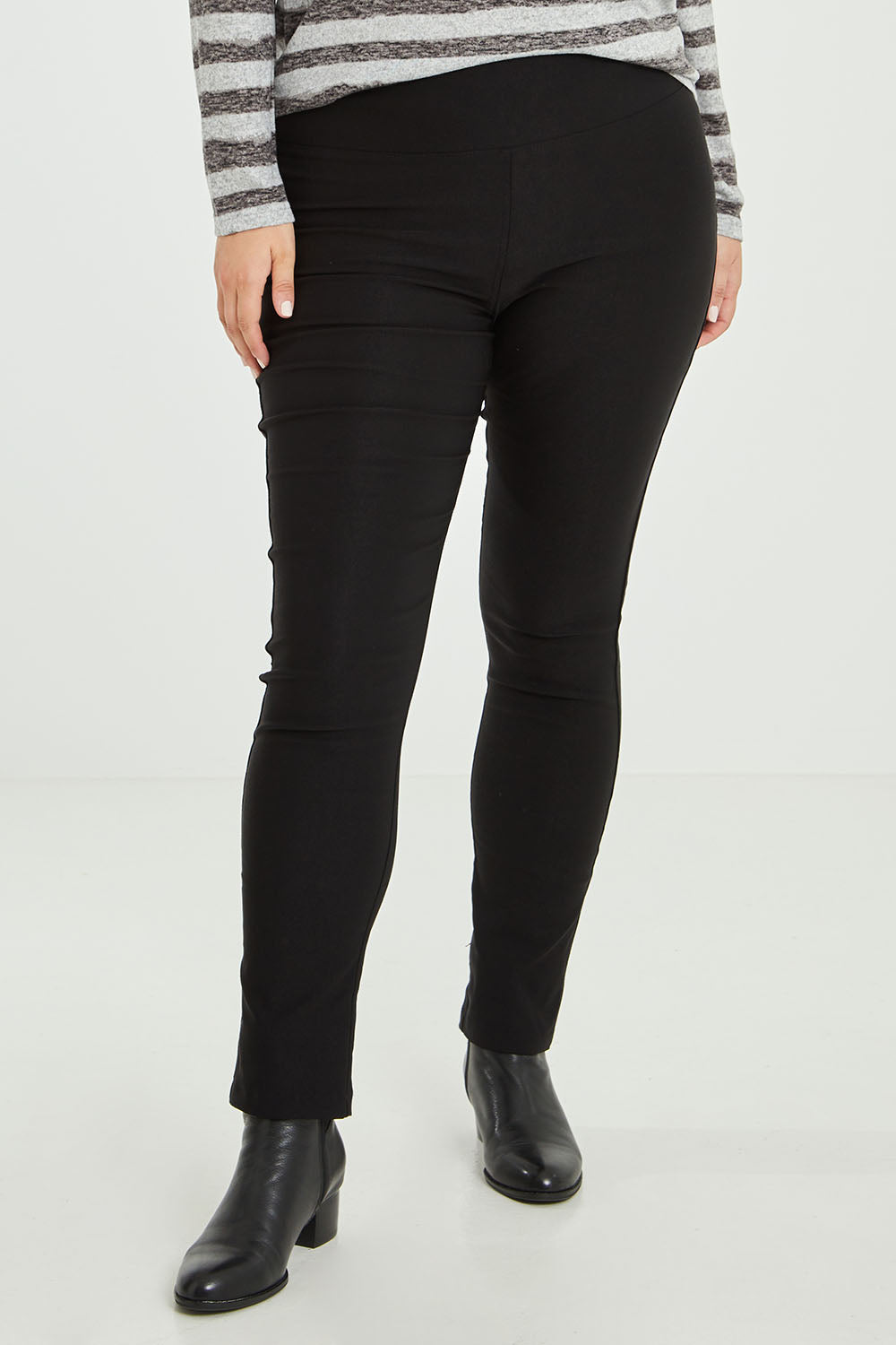 Model Jess wearing size 14 of The Brushed Bengaline Pant in colour Black (Black), from the front, cropped image