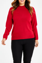 Model Laura wearing size L of The Essential Soft Jumper in colour Crimson (Red), from the front, cropped image