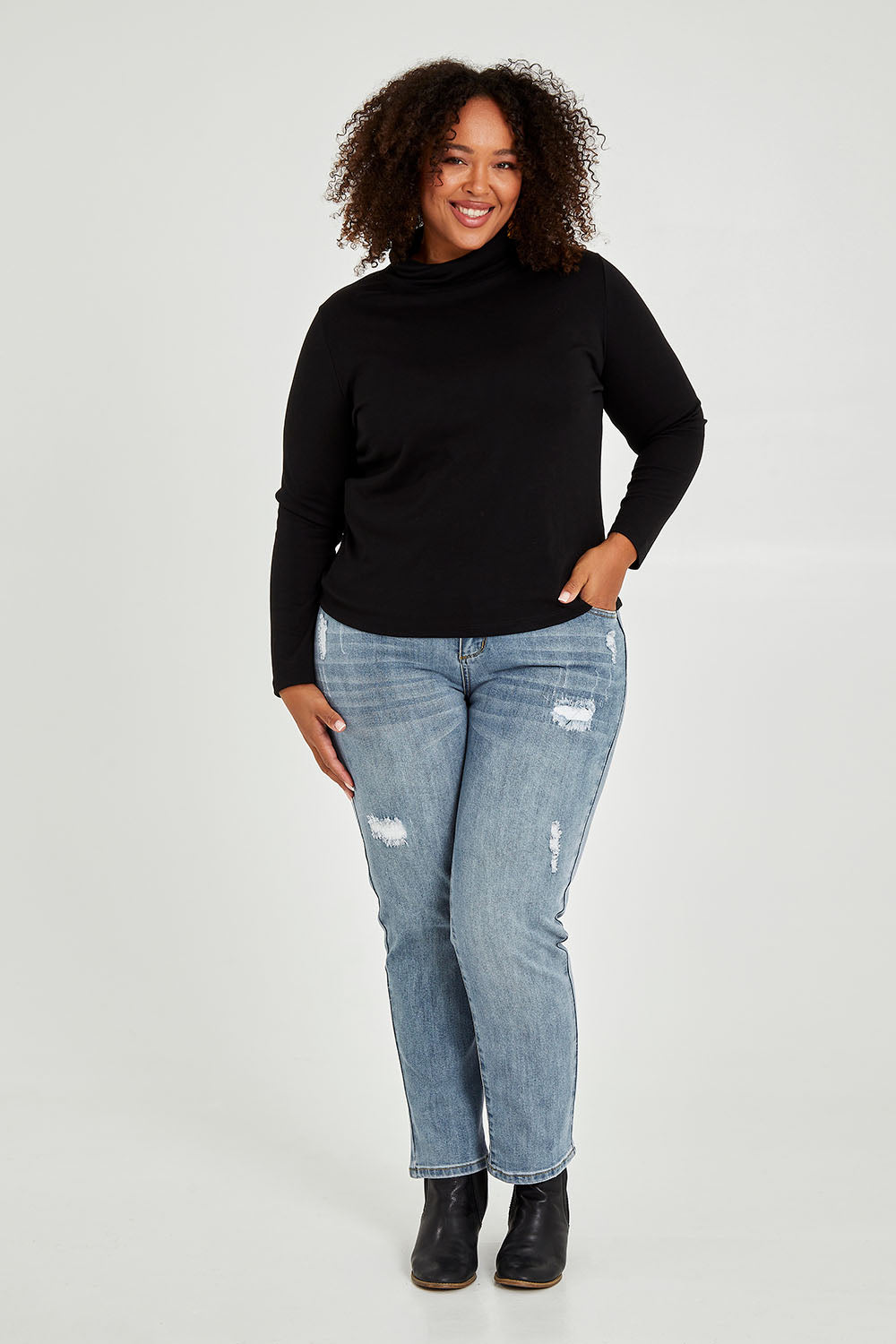 Model Alexis wearing size 16 of The Easy Wear Skivvy in colour Black (Black), from the front, showing the whole outfit