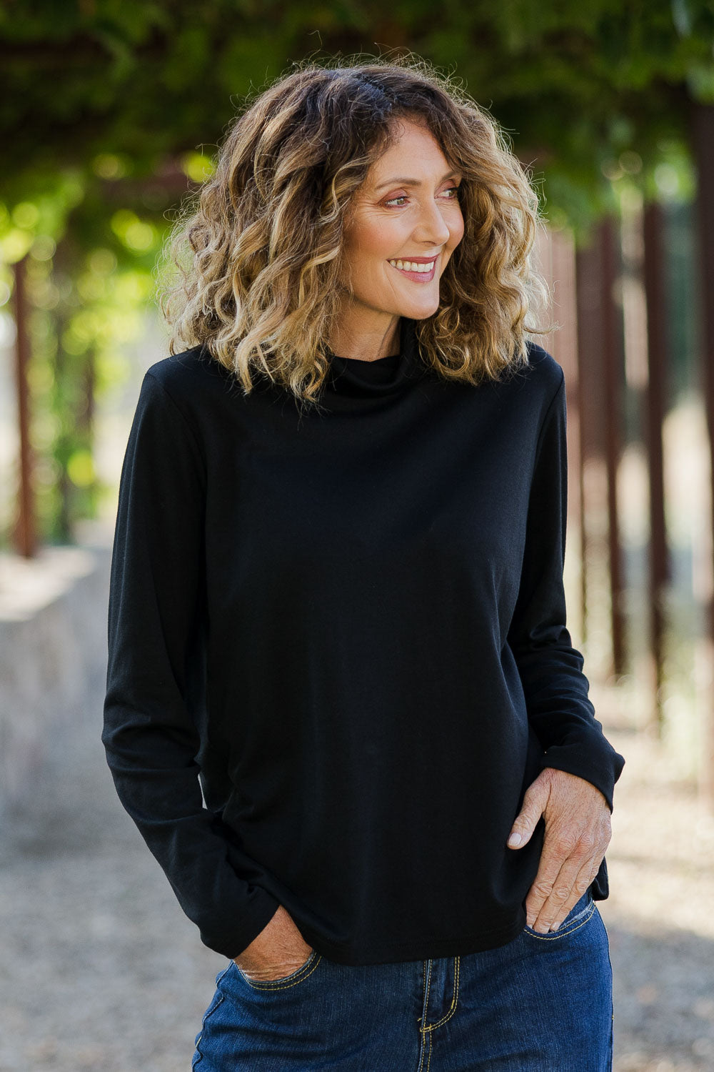 Model Emma wearing size 10 of The Easy Wear Skivvy in colour Black (Black), from the front, showing the whole outfit