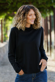Model Emma wearing size 10 of The Easy Wear Skivvy in colour Black (Black), from the front, showing the whole outfit