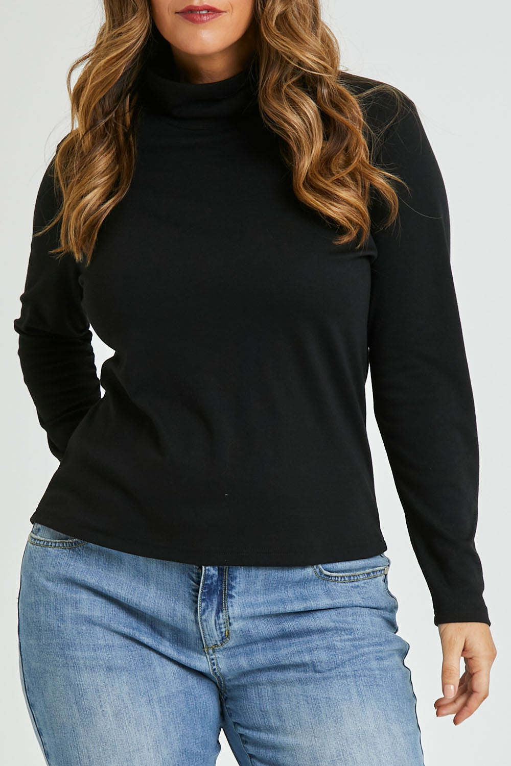 Model Laura wearing size 14 of The Easy Wear Skivvy in colour Black (Black), from the front, cropped image