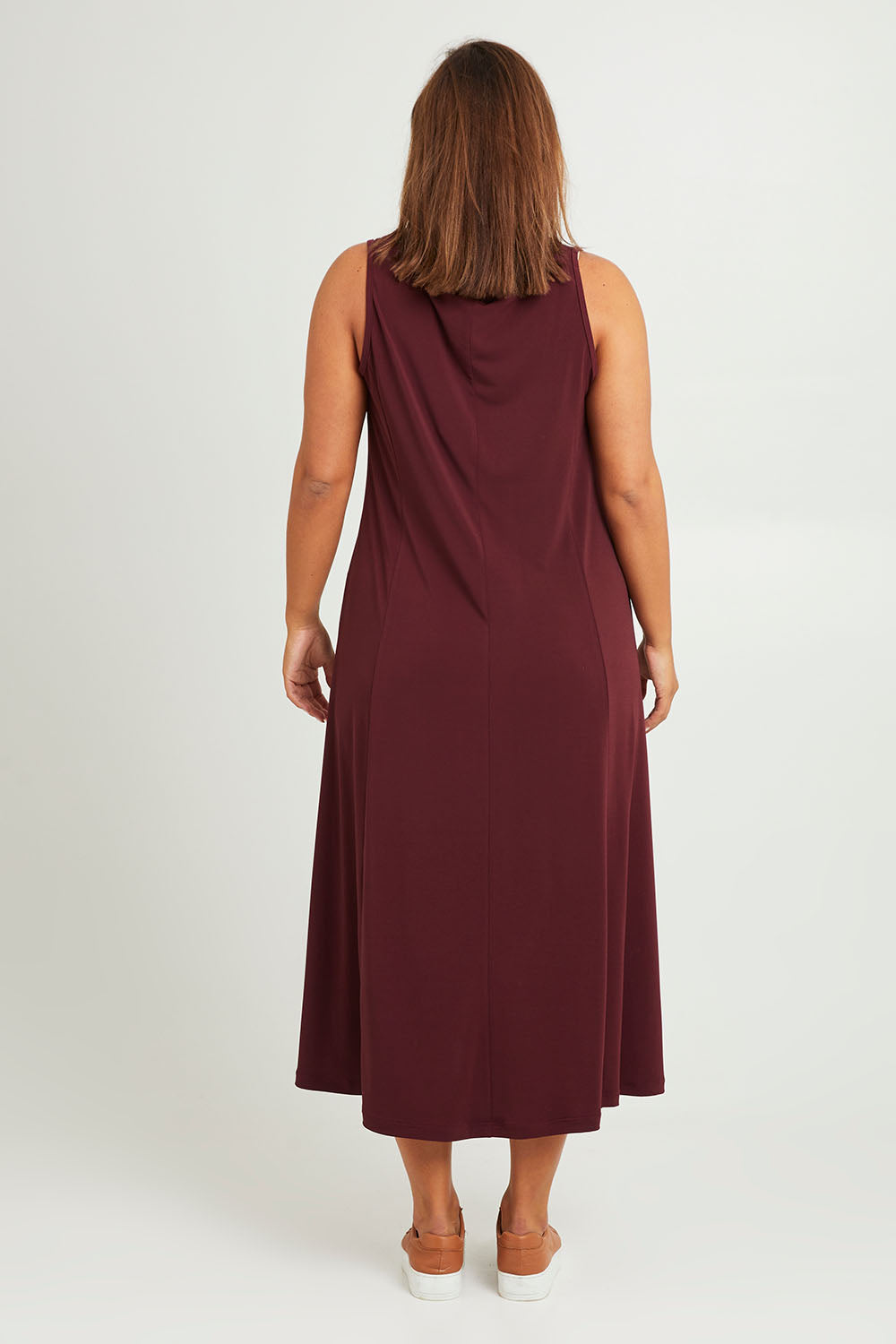 Model Monique wearing size 14 of The Recycled A Line Midi Dress in colour Burntplum (Purple), from the back