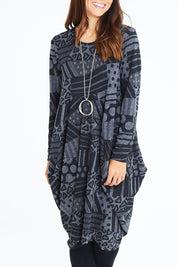 Model Cara wearing size 10 of The Jacquard Bounce Dress in colour Charcoal (Grey), from the front, cropped image