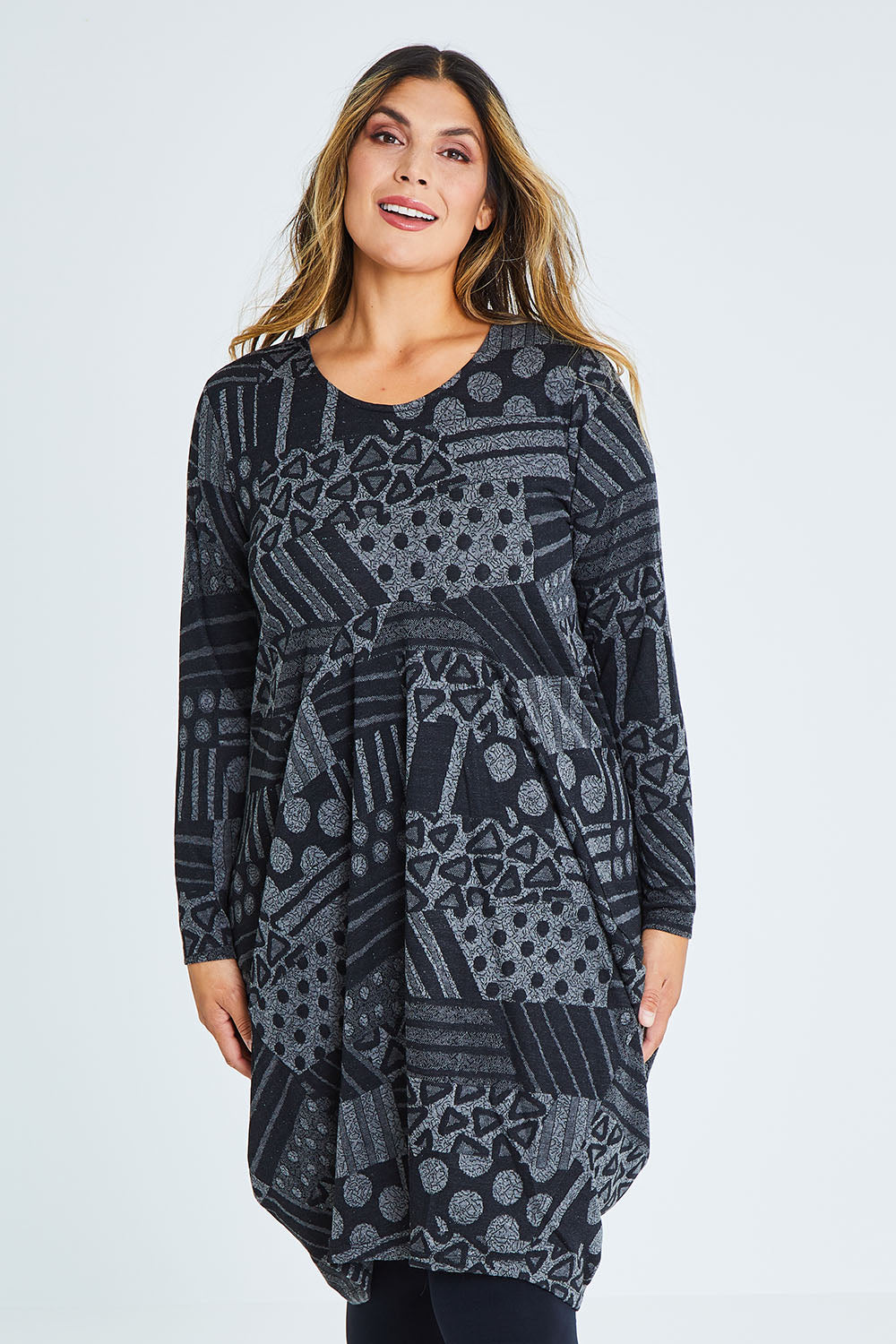 Model Palatina wearing size 16 of The Jacquard Bounce Dress in colour Charcoal (Grey), from the front, cropped image