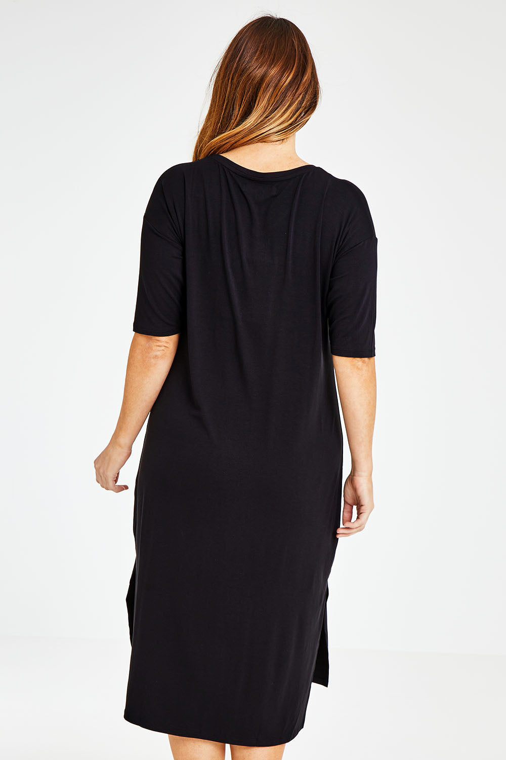 Model Laura wearing size 14 of The 3/4 Sleeve Mid Length Tee Dress in colour Black (Black), from the back